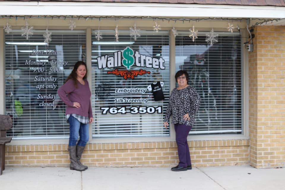 shop owners posing in front of store exterior
